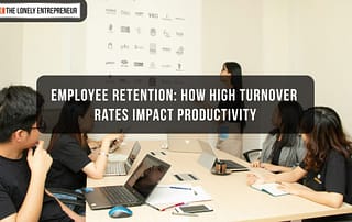 Group of office workers in a meeting regarding employee retention and how it impacts productivity of a company